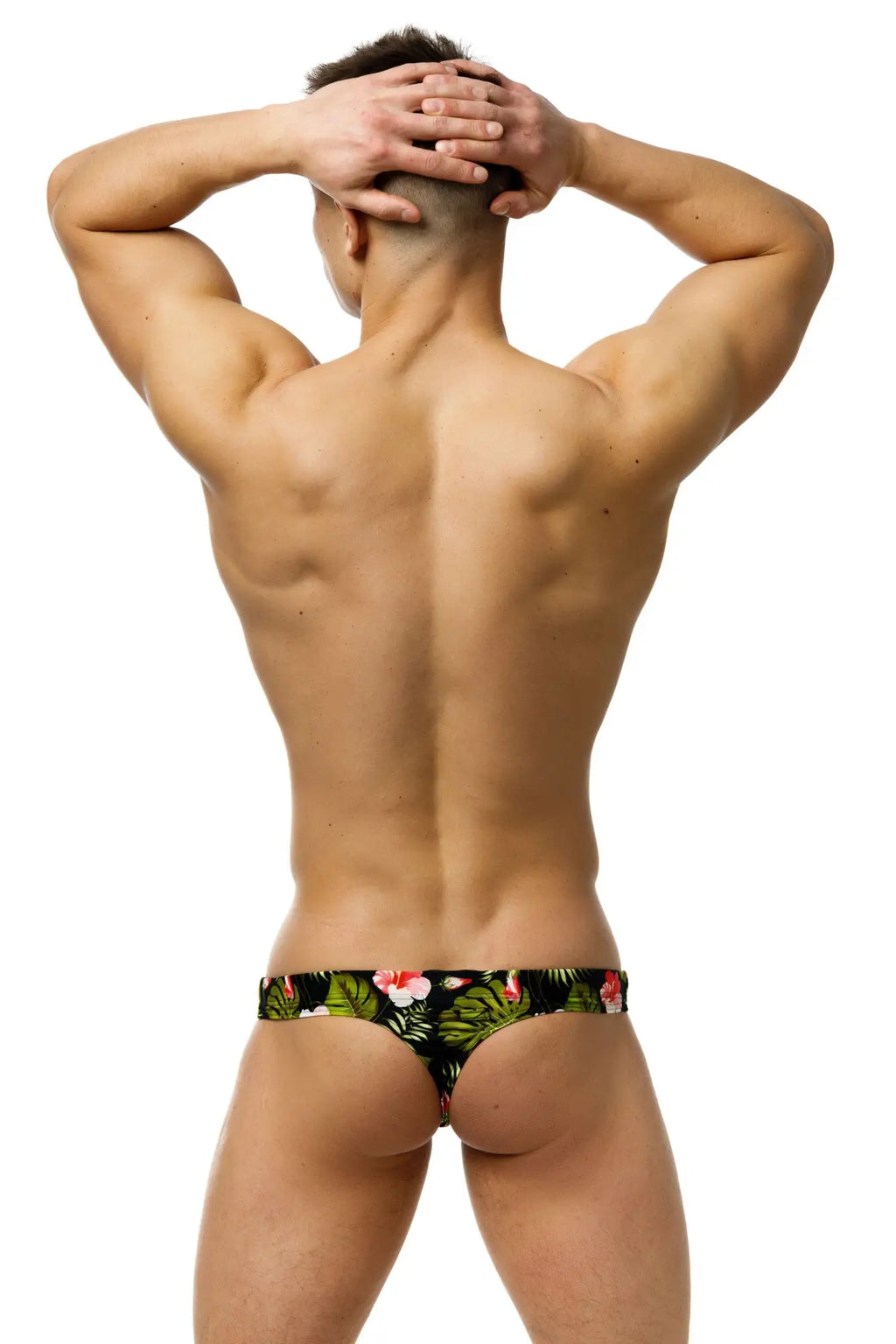 Marcuse Forrest thong swimwear black tropical print swim trunks with vibrant green leaves and pink flowers