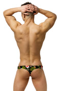Marcuse Forrest thong swimwear black tropical print swim trunks with vibrant green leaves and pink flowers