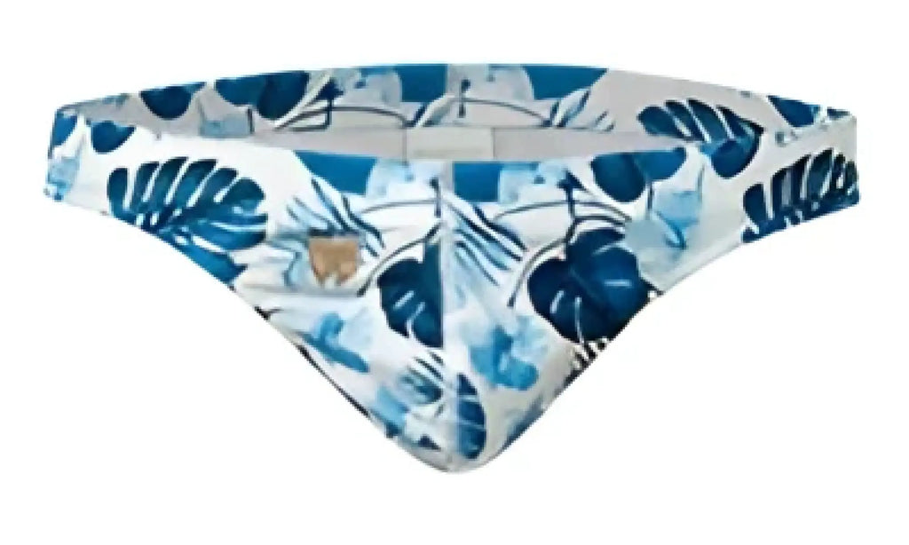 Blue and white tropical leaf-patterned Marcuse Forrest thong swimwear designed for beach and pool use