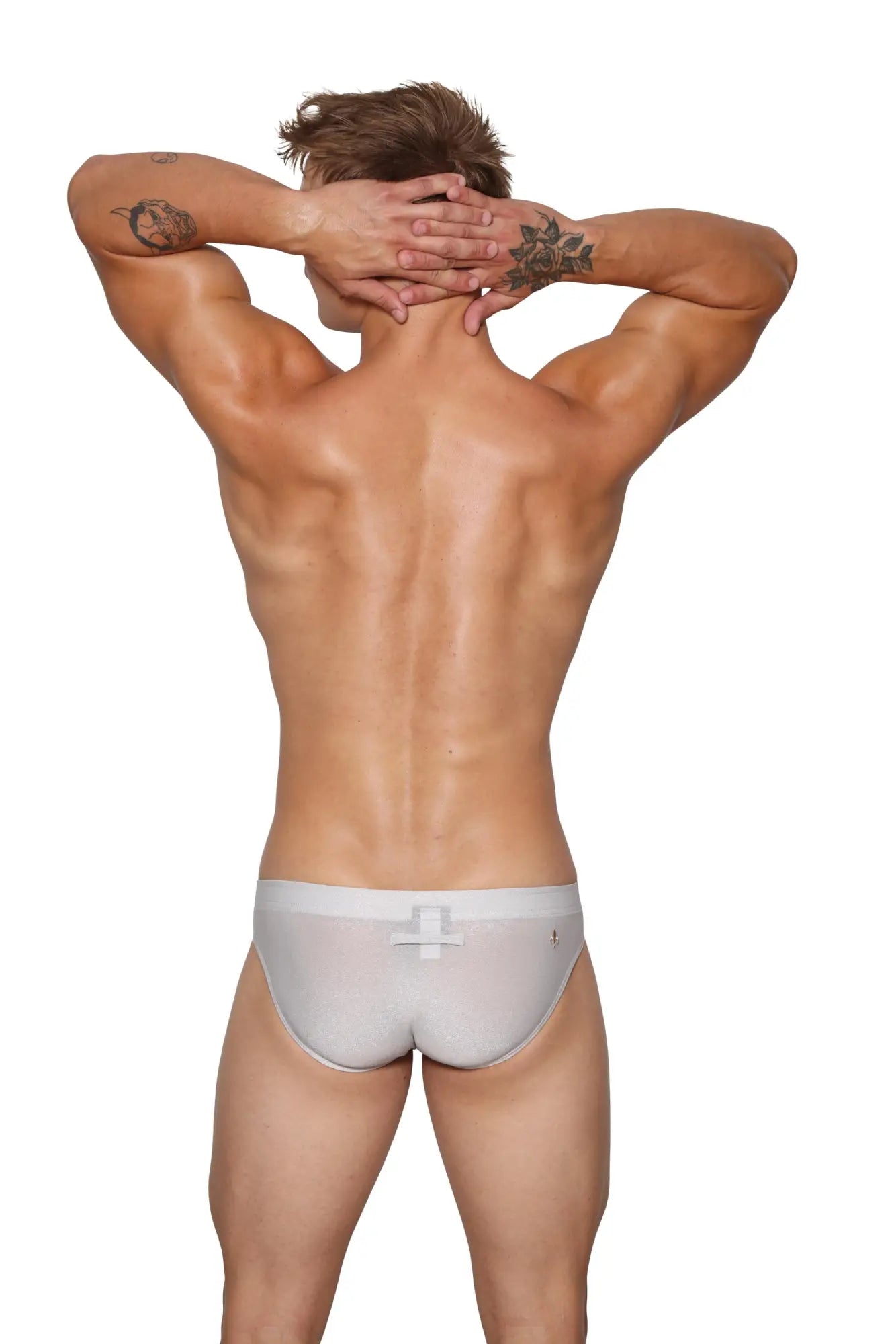 Back view of marcuse glisten brief underwear in white sheer fabric with subtle cross-shaped back closure