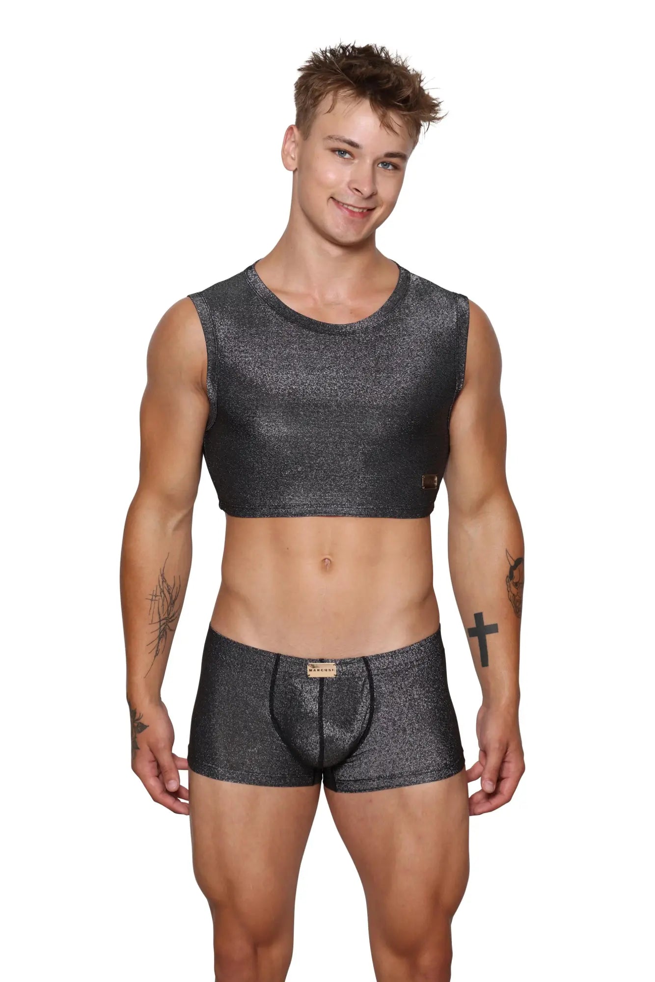 A man wearing a shimmering dark gray marcuse glisten sleeveless crop tank with glittery texture and matching boxer briefs