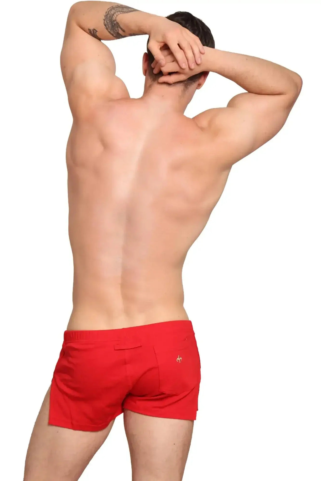 Back side of marcuse hansar shorts showing red swim trunks with a small gold logo on the back pocket