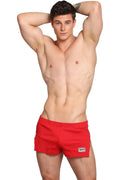 Red Marcuse Hansar athletic shorts with a small white logo patch on the lower right leg for active wear