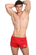 Red Marcuse Hansar athletic shorts with a small white logo patch on the lower right leg for active wear