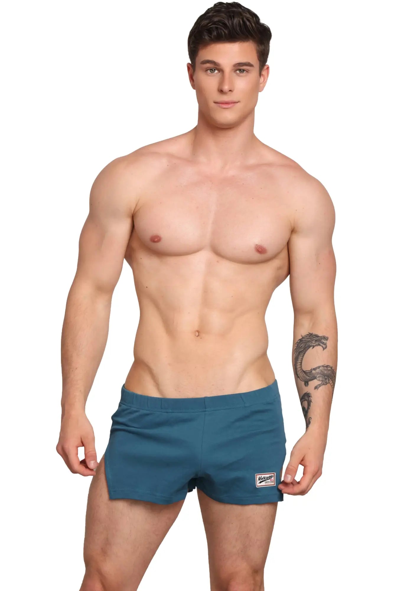 Marcuse hansar shorts teal swim trunks with small white and black logo patch on lower right leg