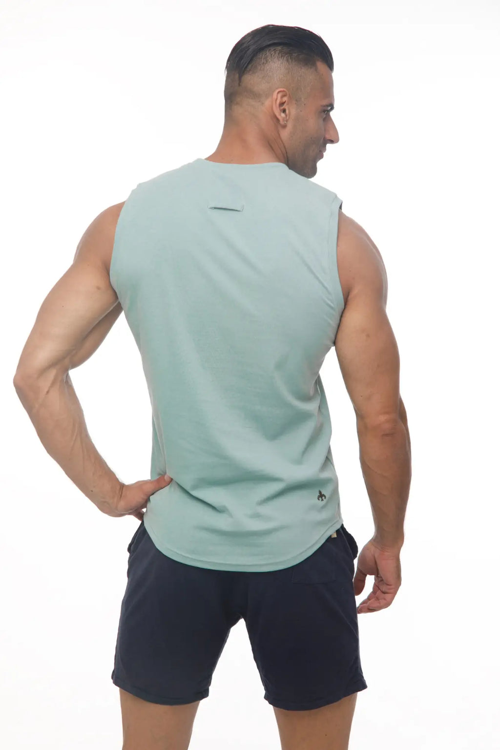Light mint green sleeveless Marcuse Hero tank top showing back with subtle brand logo on lower back for athletic wear