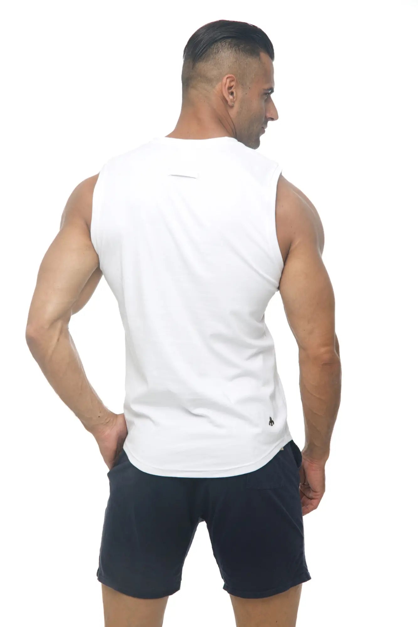 Back view of marcuse hero tank top white sleeveless athletic tank with subtle logo on lower back for training