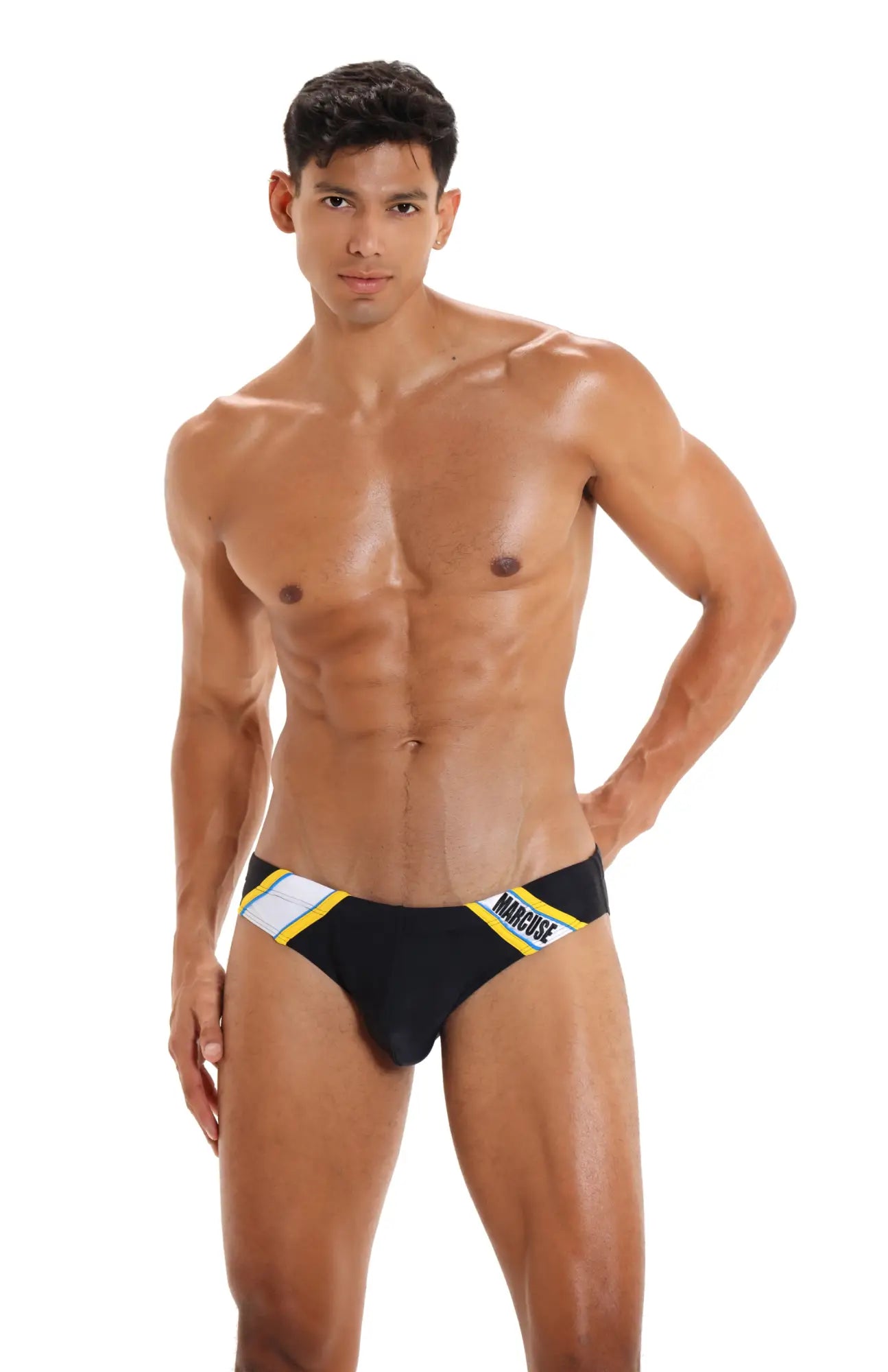 Black marcuse homme bikini swimwear briefs with yellow and white striped trim featuring magnus brand name