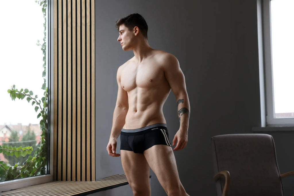 Marcuse Huxley boxer underwear in black athletic briefs with white stripes and a subtle logo on the waistband