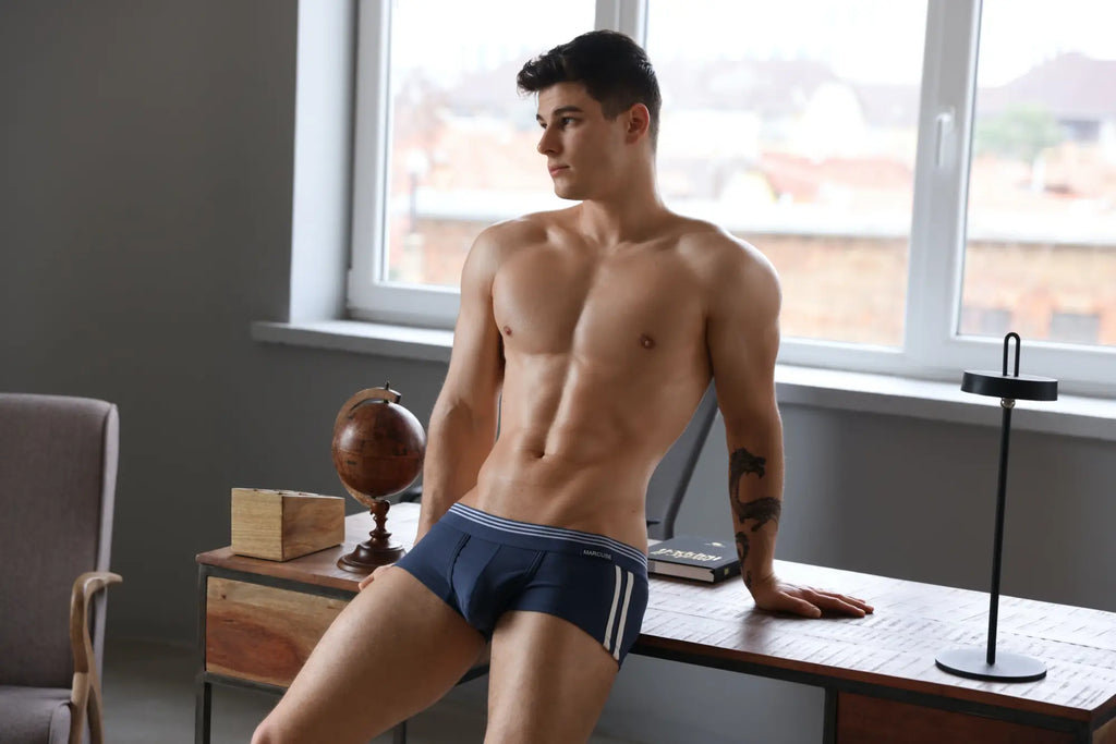 Navy blue Marcuse Huxley boxer briefs with white stripes and a subtle logo on the waistband made from soft fabric