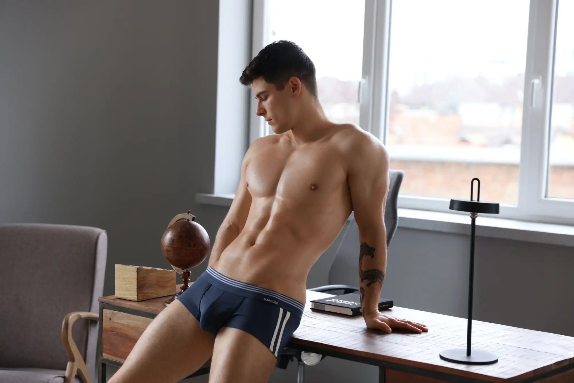 Marcuse Huxley boxer underwear in navy blue briefs with white stripes and a subtle logo on the waistband