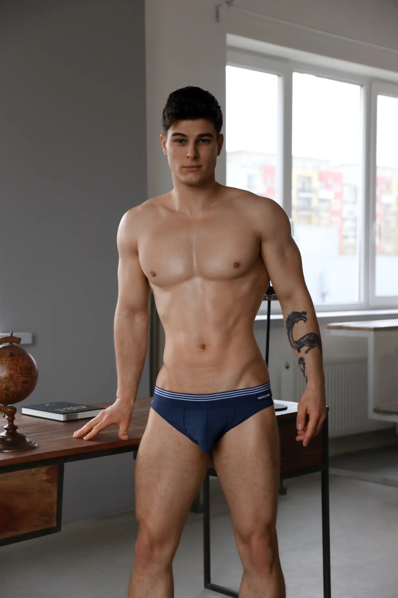 Navy blue Marcuse Huxley brief underwear with white striped trim made from soft breathable fabric