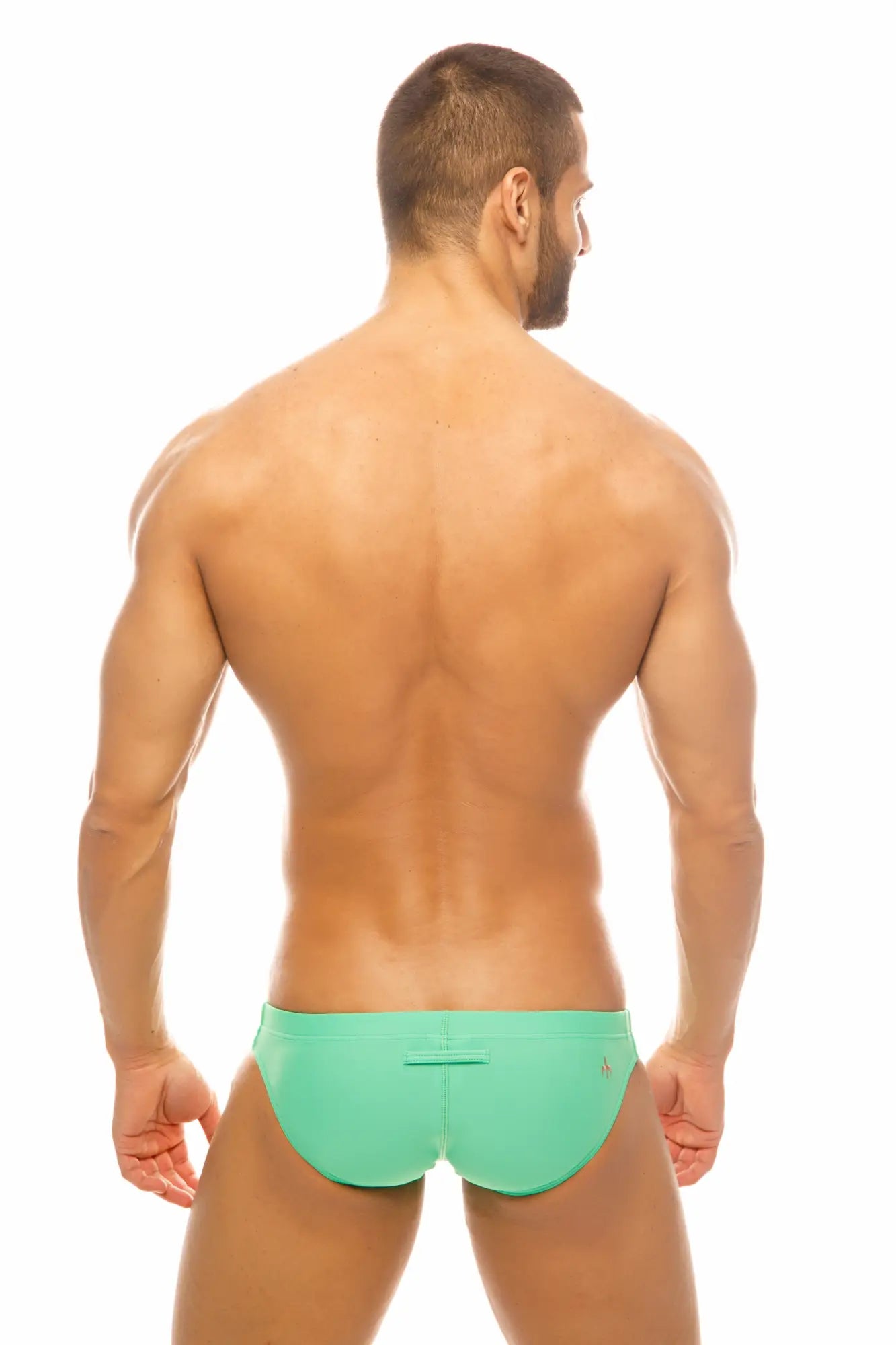 A man wearing vibrant mint green Marcuse Inflate bikini swimwear with a simple sleek design front view