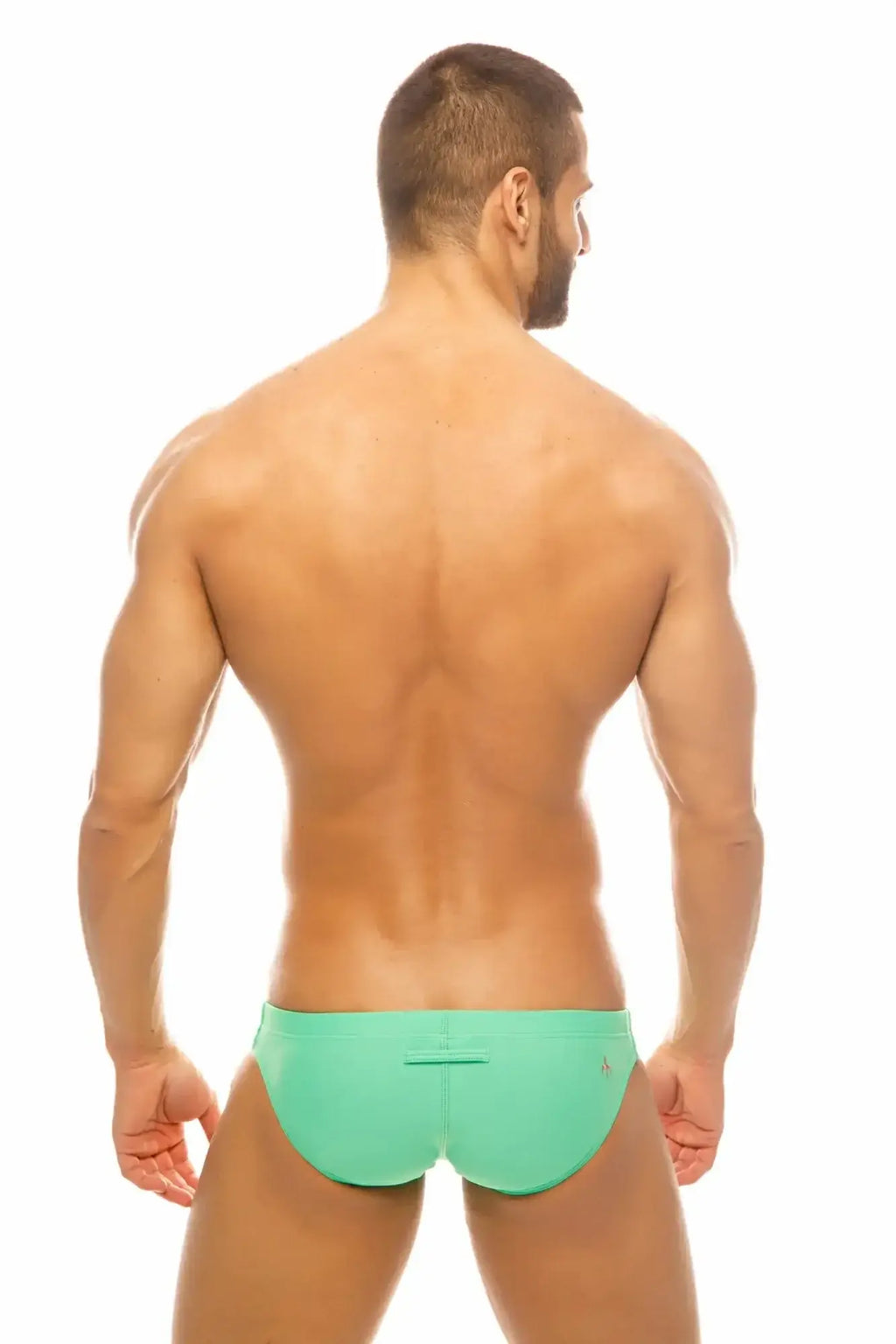 A man wearing vibrant mint green Marcuse Inflate bikini swimwear with a simple sleek design front view