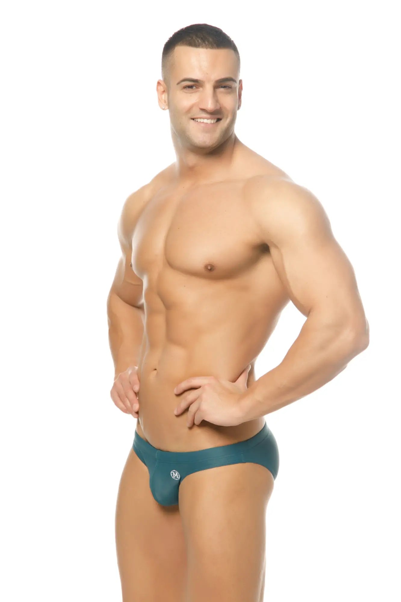 Teal-colored form-fitting marcuse inflate bikini swimwear briefs with a small circular logo on the front