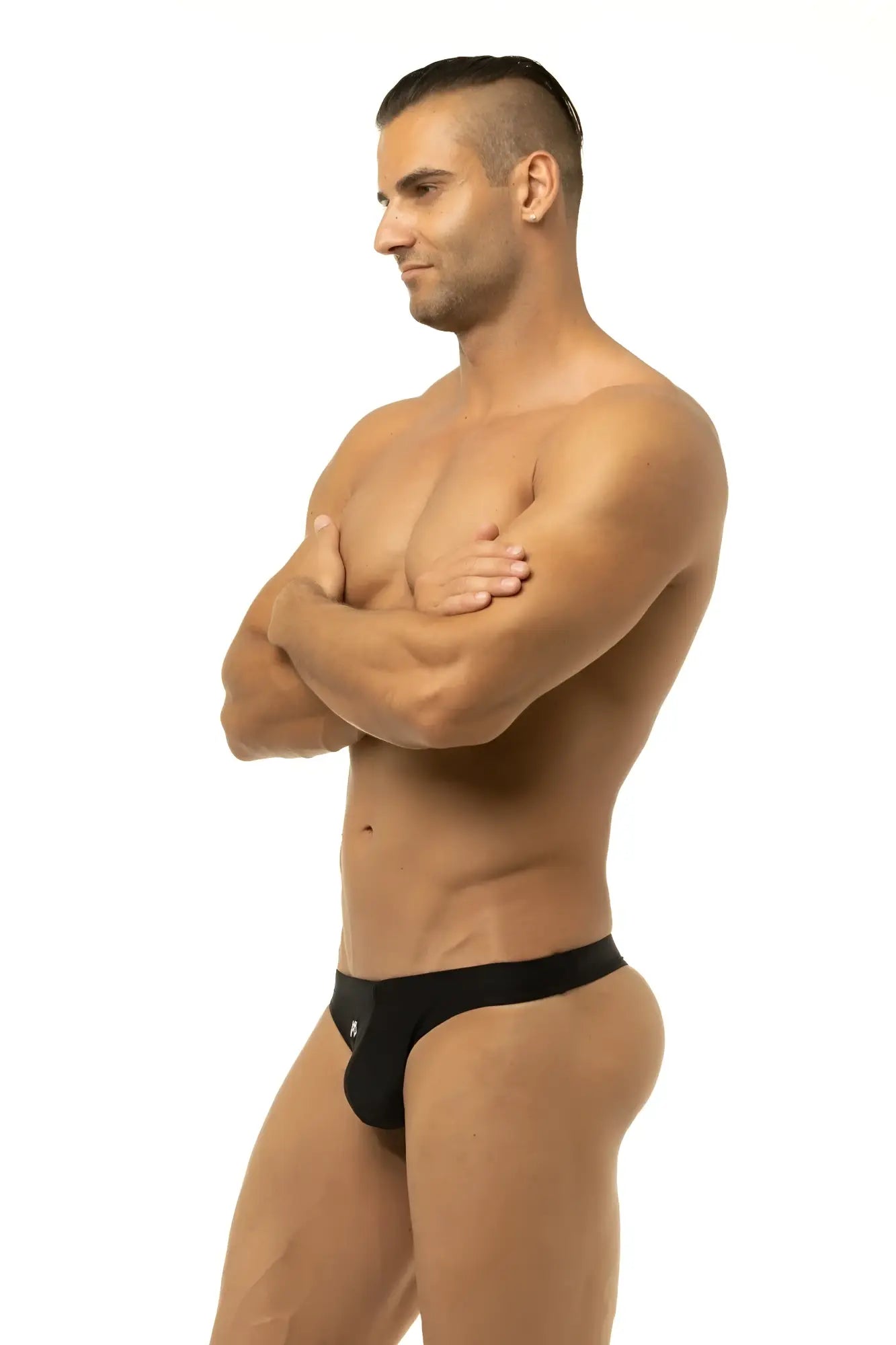 Black form-fitting briefs with a sleek minimalist design from Marcuse Inflate thong swimwear collection visible from back side