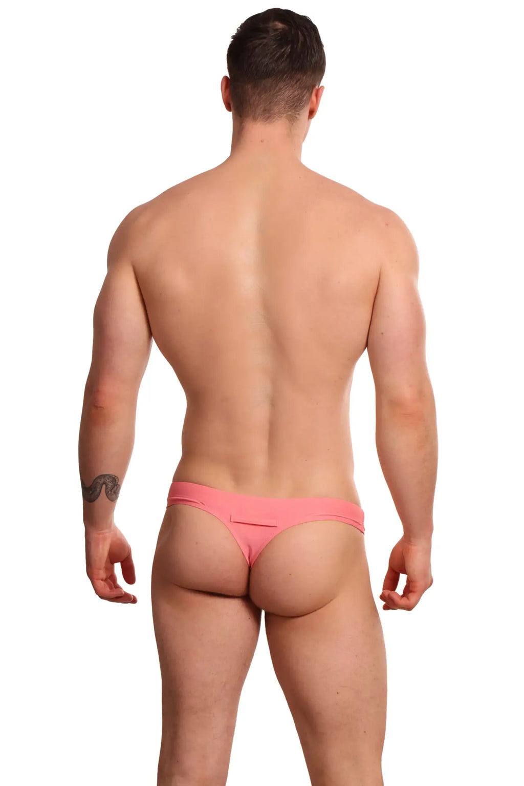 Back view of marcuse inflate thong swimwear in pink featuring a small rectangular flap at the back