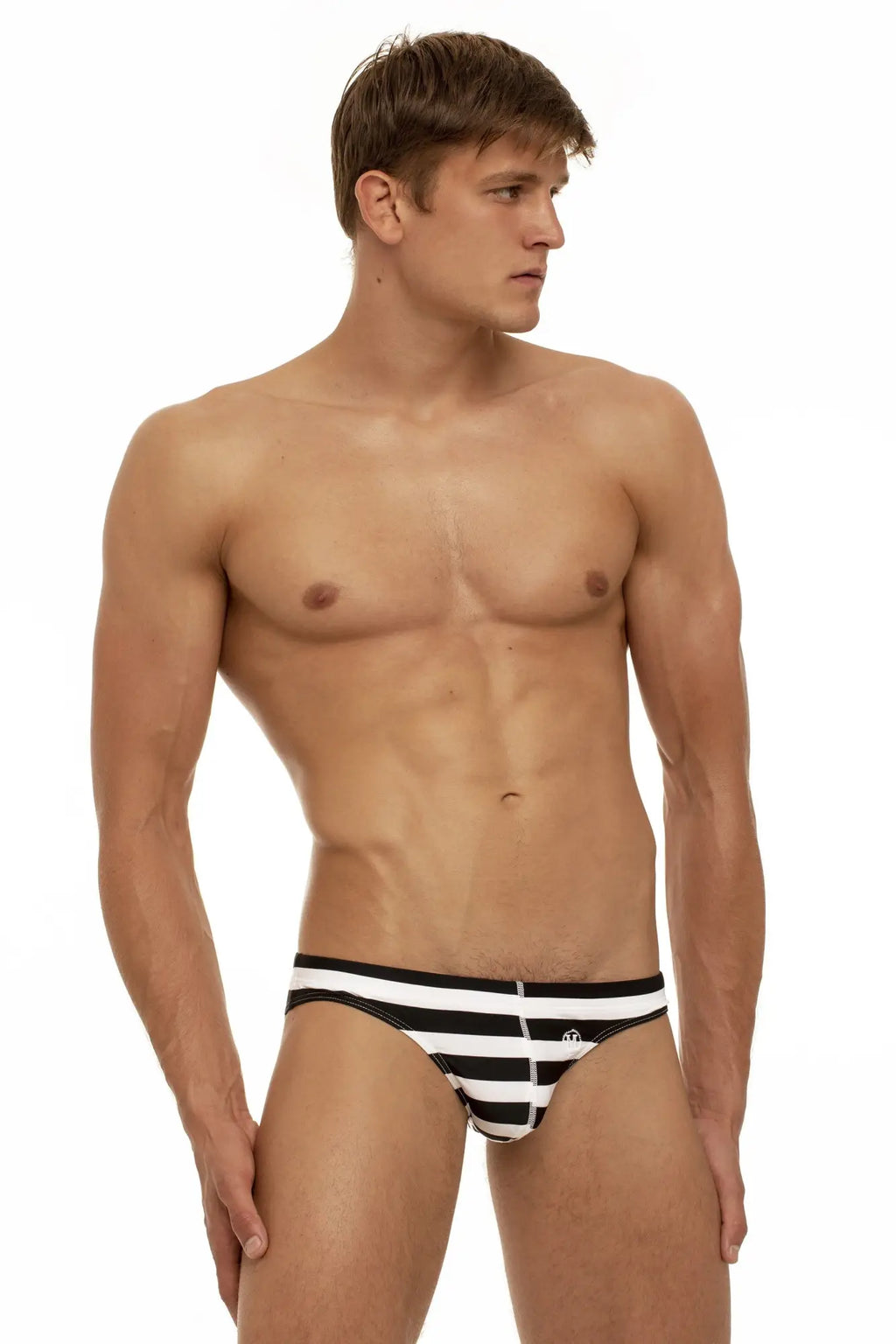 Marcuse Journée brief swimwear featuring black and white striped swim trunks with a small front logo