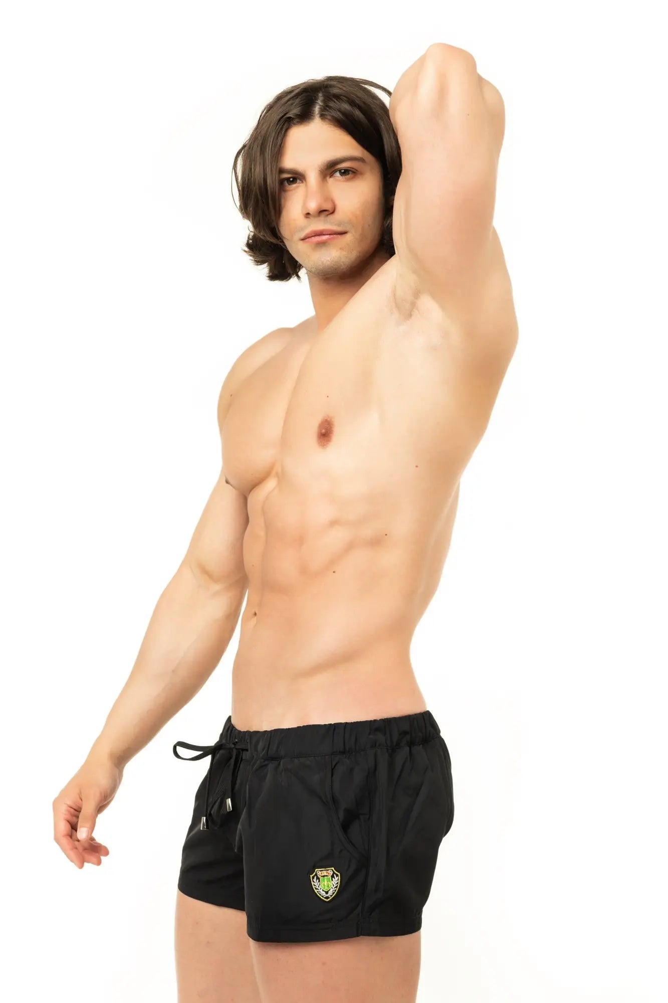 Marcuse league shorts are black athletic shorts with a drawstring waistband and a green shield logo on the left thigh