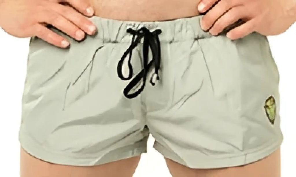 Marcuse league shorts khaki cargo shorts with black drawstrings and a small yellow logo on the left thigh