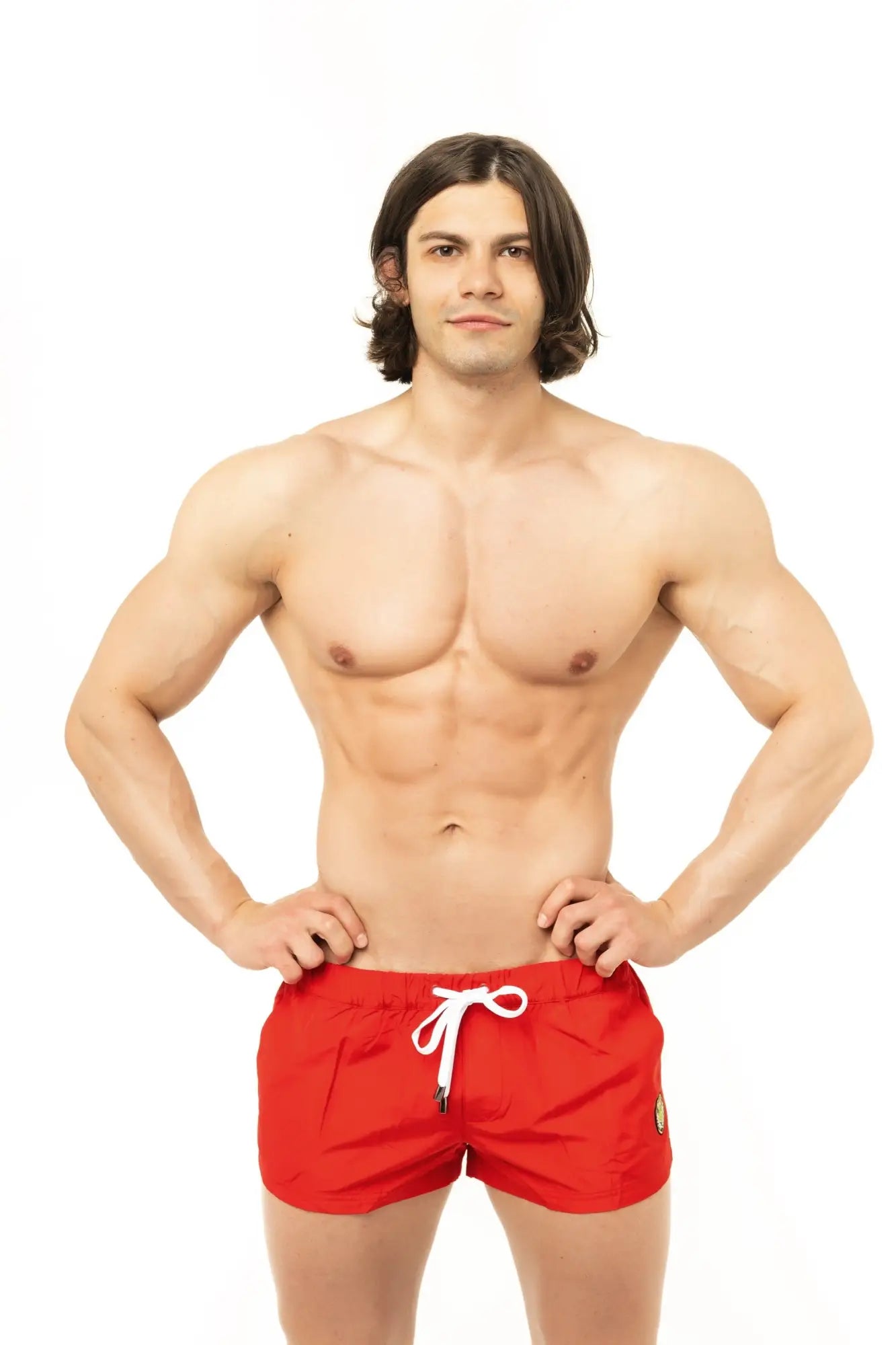 Red Marcuse League swim shorts with white drawstring and small side logo for casual beachwear