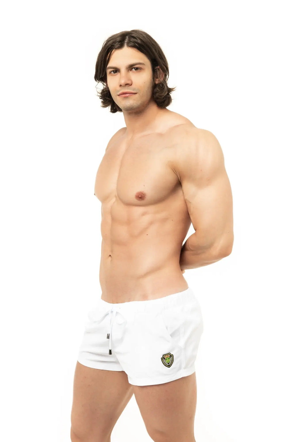 White marcuse league athletic shorts with a small embroidered logo on the lower left leg