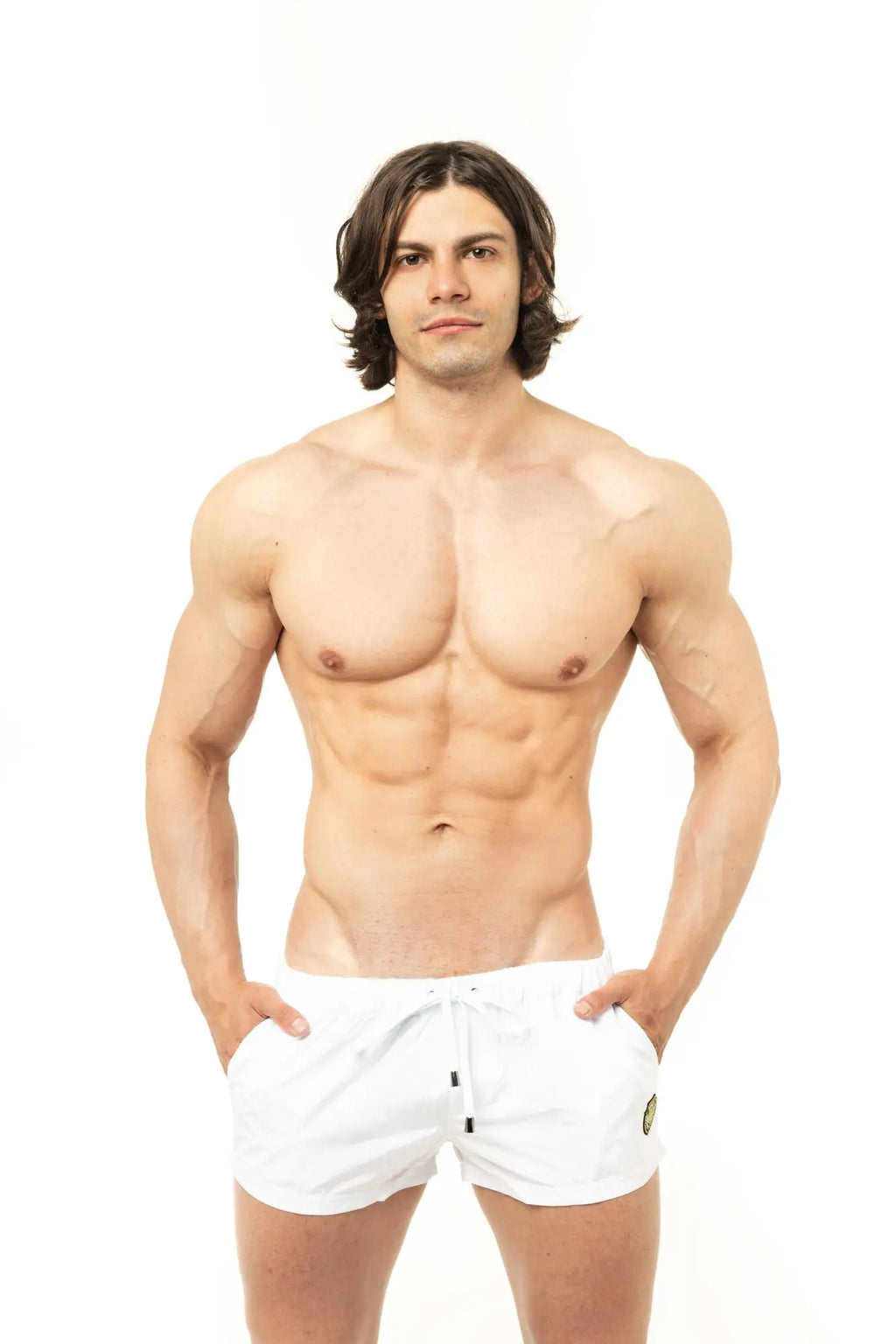 White marcuse league athletic shorts with drawstring waist and small green logo on the lower right leg