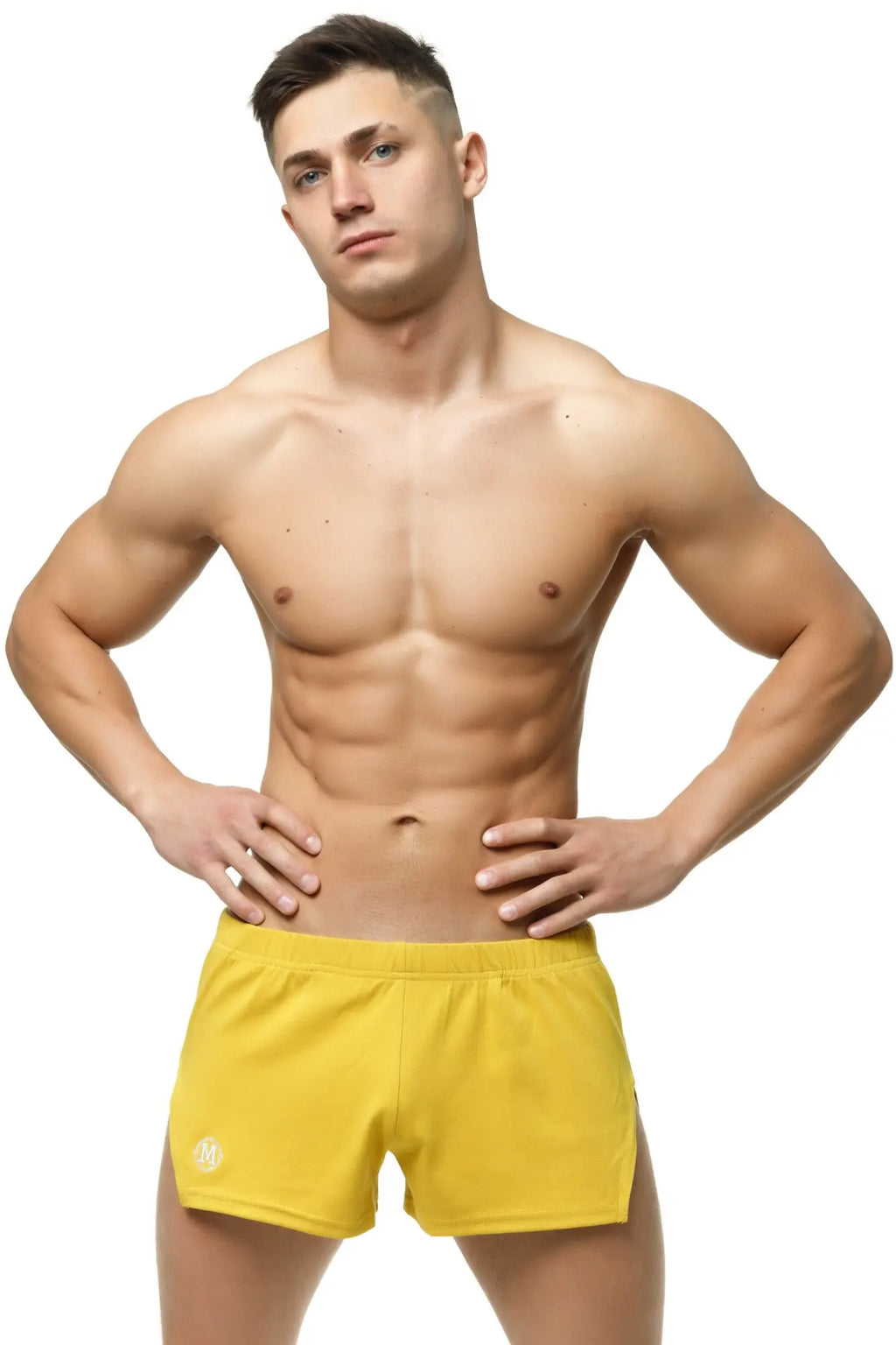 Bright yellow Marcuse leisure shorts with a subtle logo on the lower left leg designed for athletic use