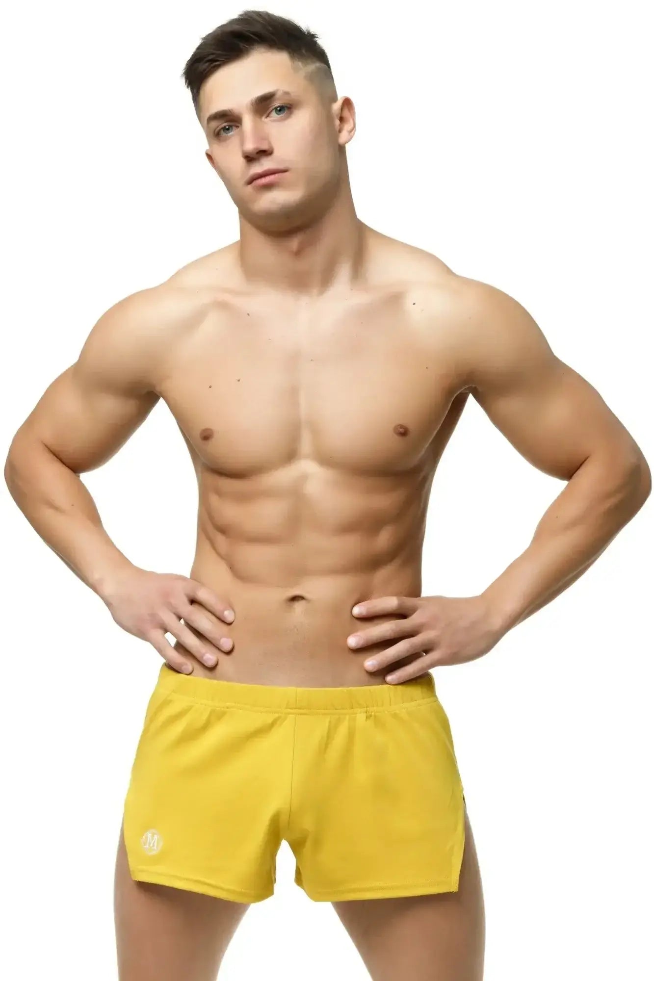 Bright yellow Marcuse leisure shorts with a subtle logo on the lower left leg designed for athletic use