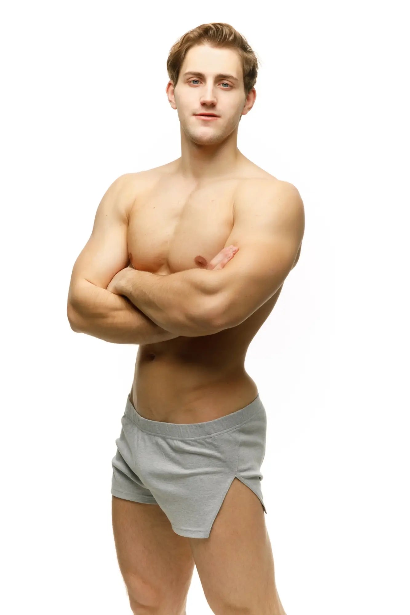 A pair of light gray marcuse leisure shorts with smooth fabric side slits and athletic cut briefs design
