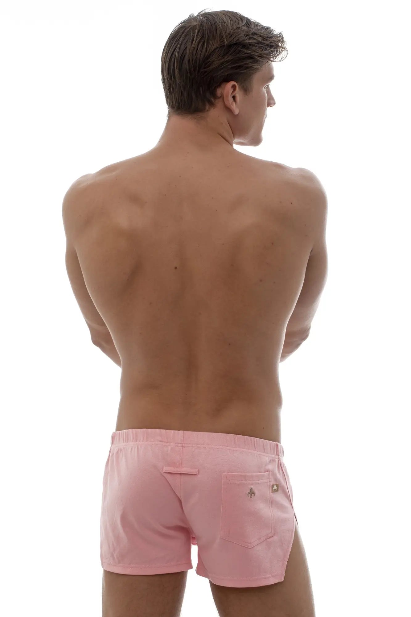 Back side of pink marcuse leisure shorts with subtle logo on back pocket made of athletic fabric for active use