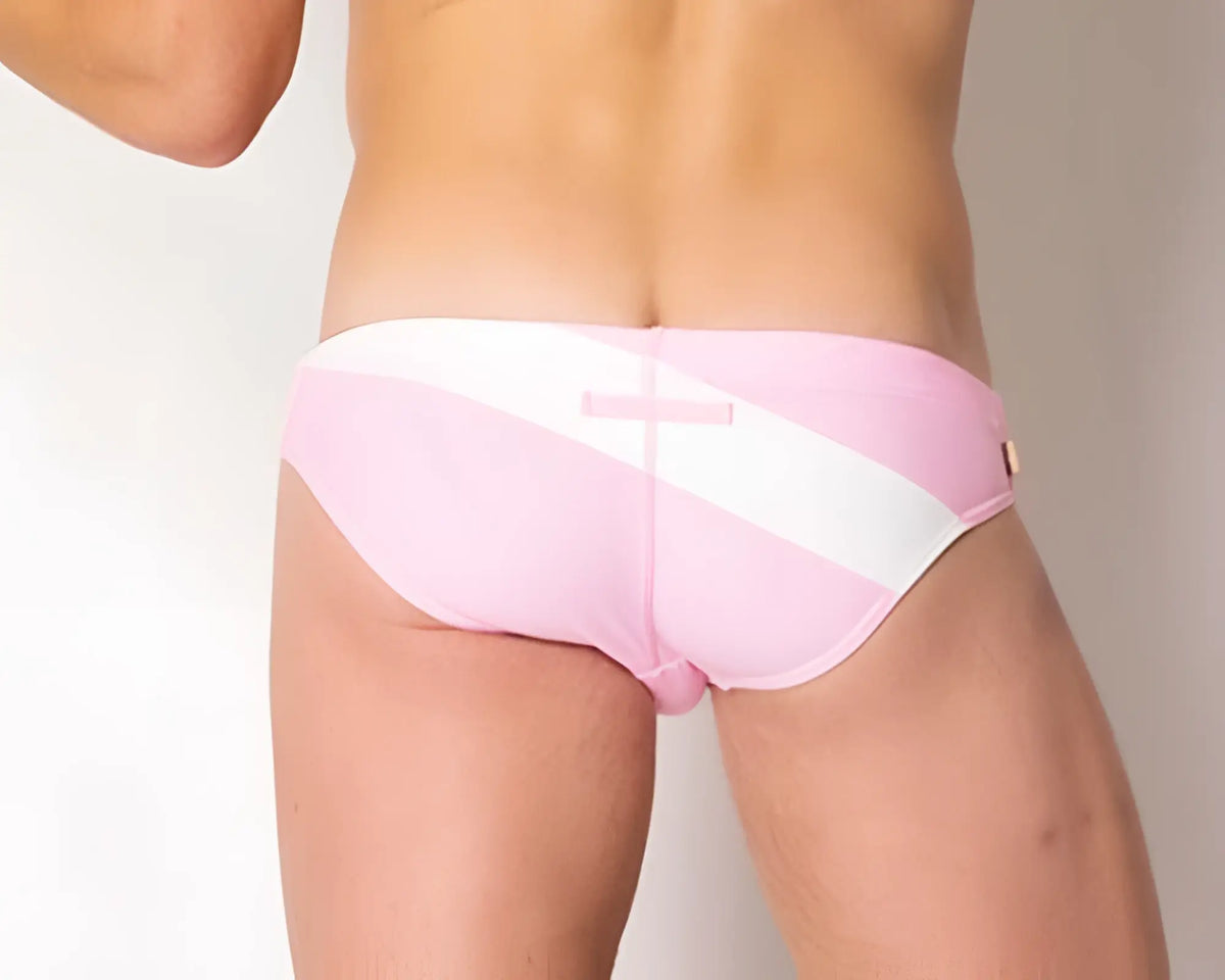 Back view of marcuse ma_xtreme swimwear pink and white diagonal-striped swim trunks with a pink rectangular tag