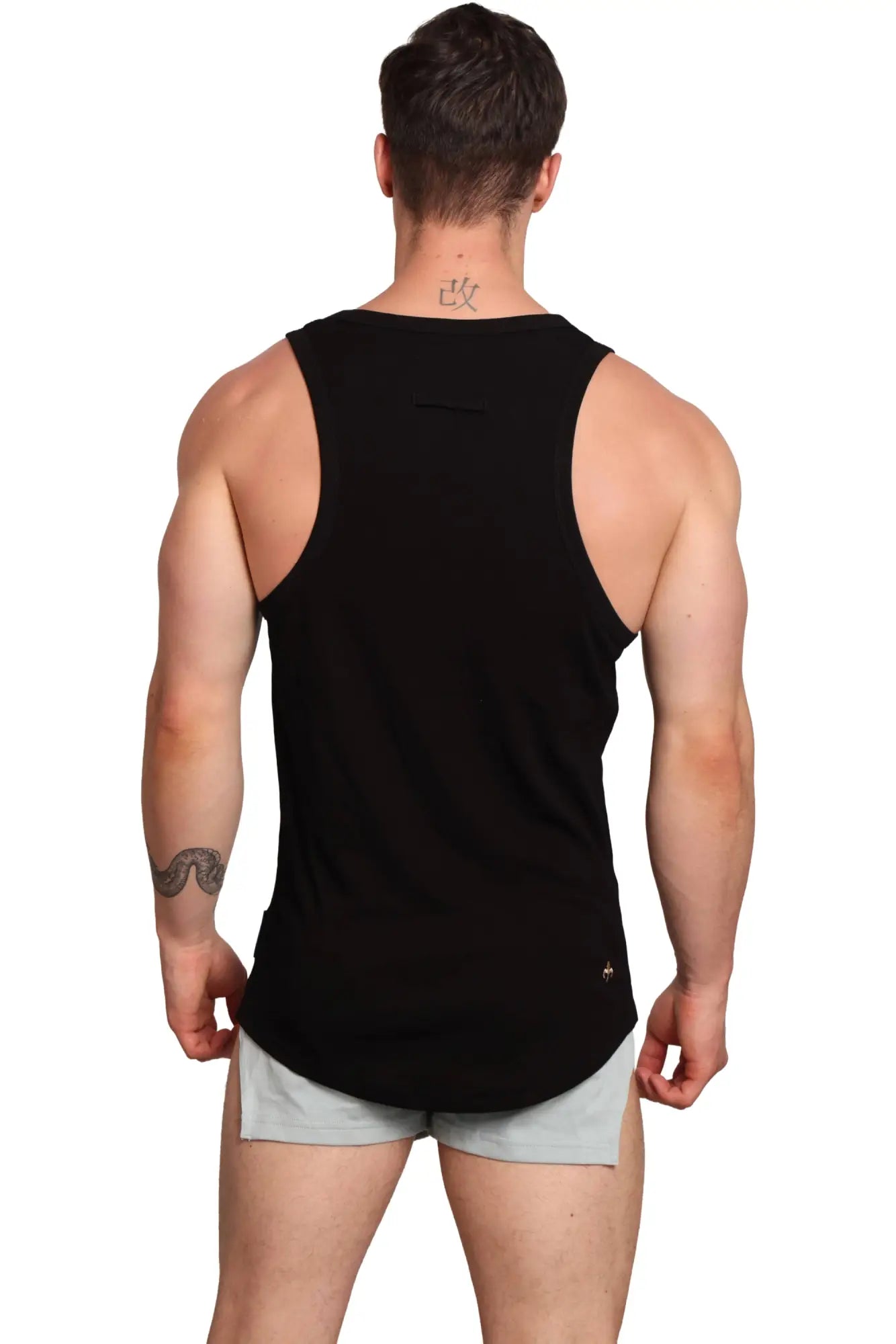 Black sleeveless Marcuse Monsieur tank top with curved hem and subtle logo on lower right side for athletic wear