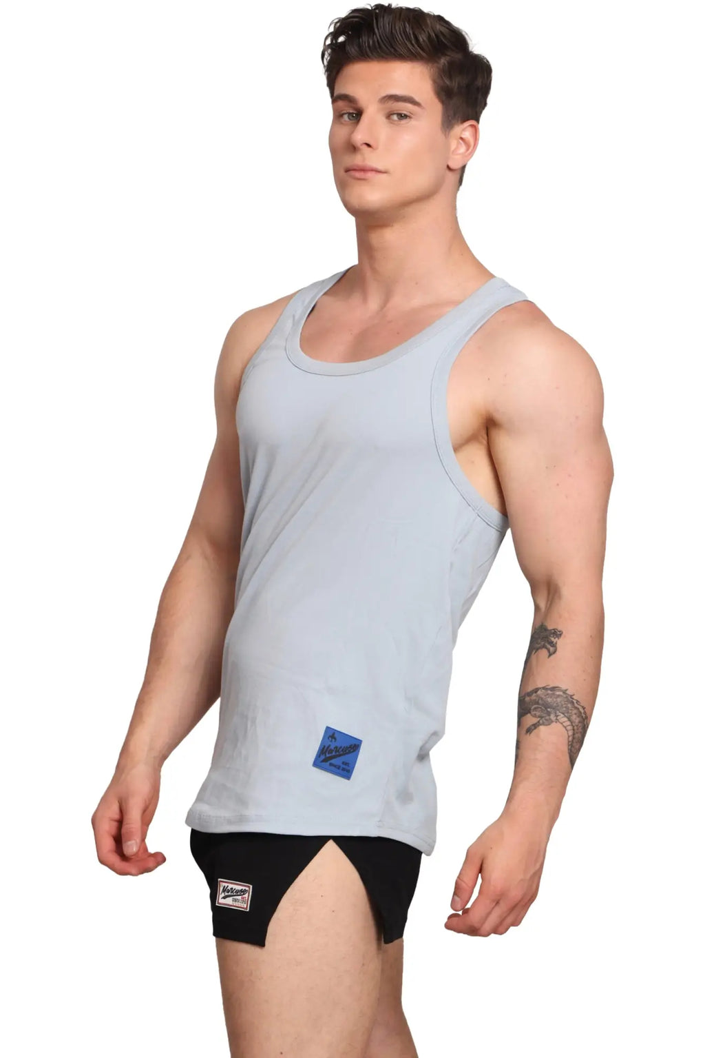 Light blue sleeveless Marcuse Monsieur tank top with a small rectangular patch on the lower front perfect for casual wear