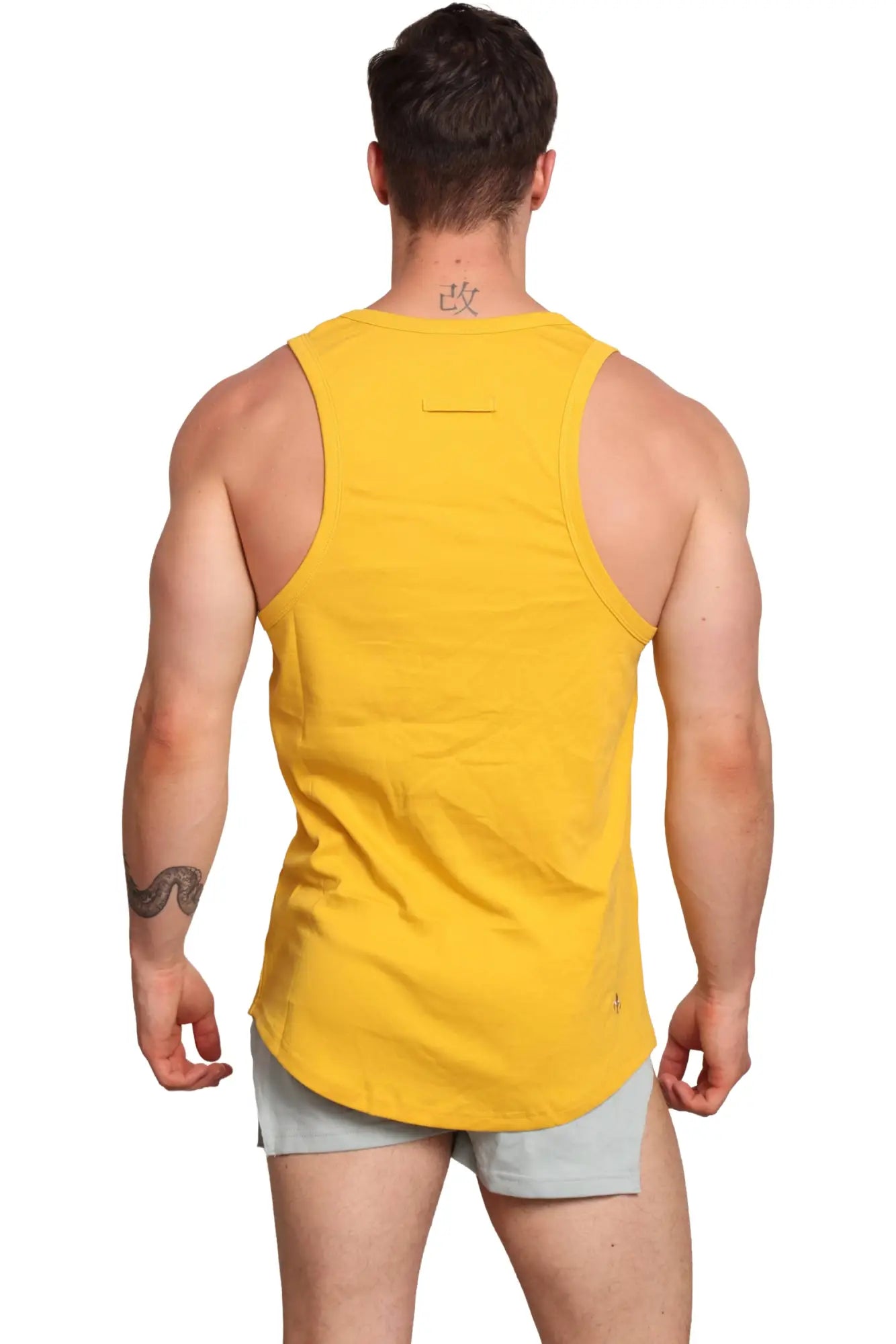 Yellow sleeveless marcuse monsieur tank top made of breathable fabric for athletic performance and casual wear