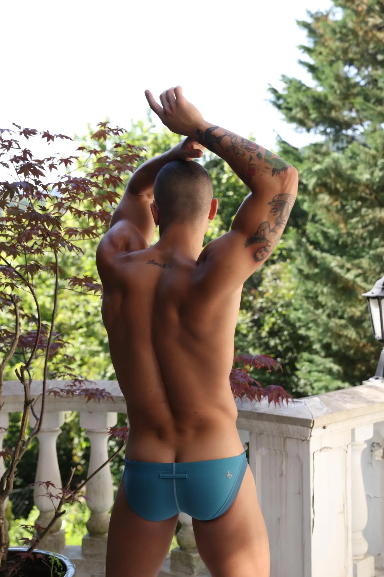 Blue marcuse montano bikini swimwear swim trunks with small logo on back side for swimming and beachwear