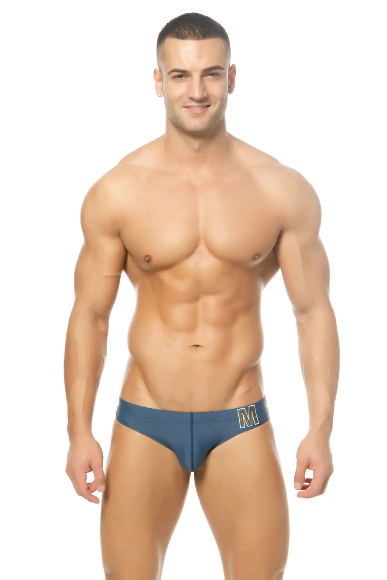 Blue men’s Marcuse Mpire bikini swimwear briefs with white m logo on waistband made for swimming and beachwear