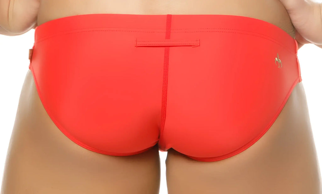 Bright red Marcuse Mpire bikini swimwear with sleek form-fitting trunks and a small gold logo on the side