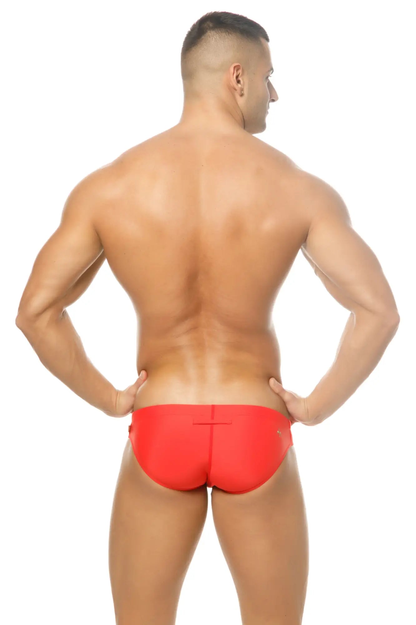 Bright red form-fitting swim trunks with a sleek minimalist design from Marcuse Mpire bikini swimwear collection