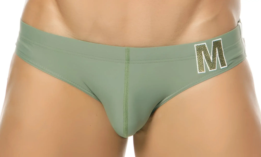 Olive green marcuse mpire bikini swimwear briefs with a glittery gold m logo on the waistband