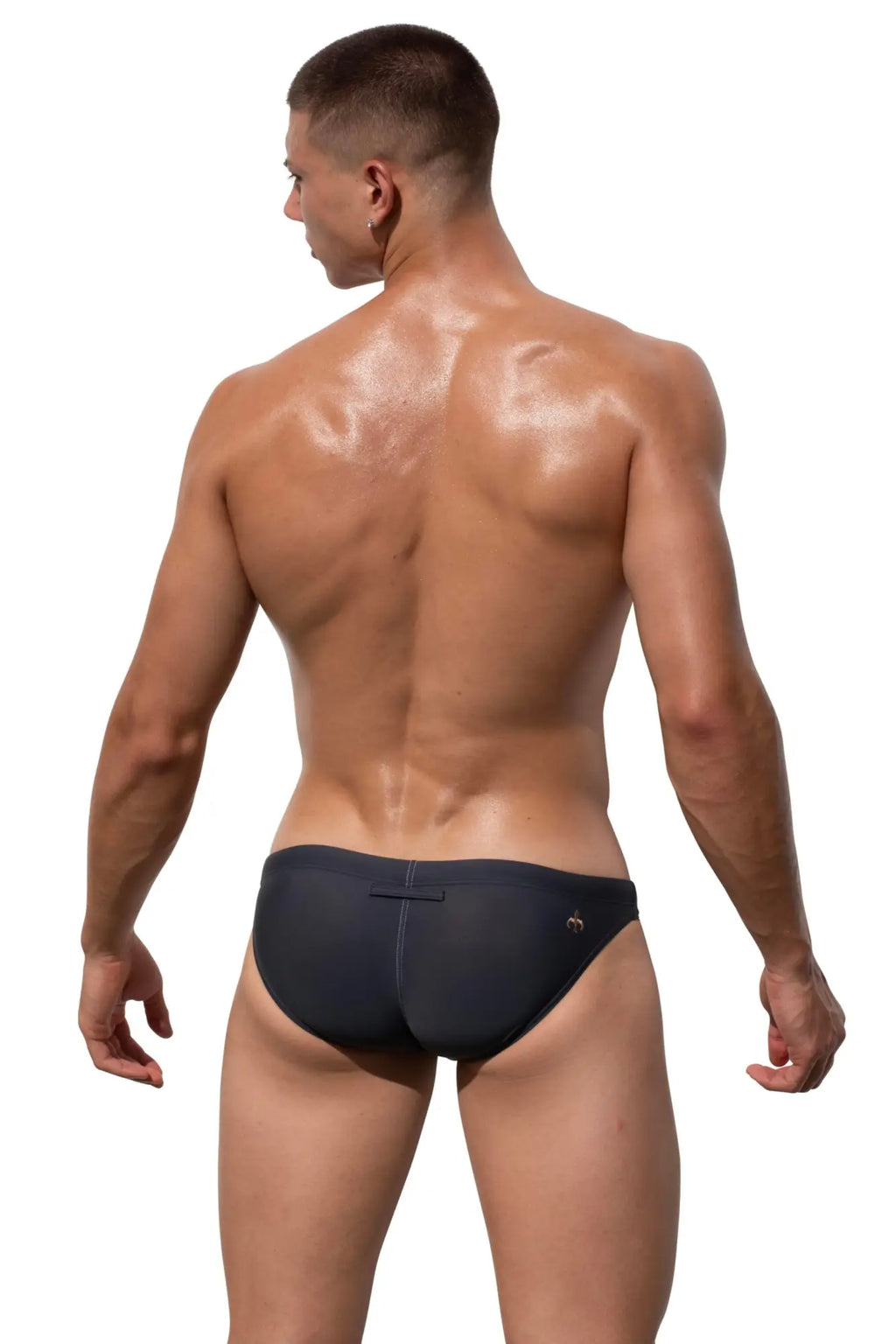 Back side view of black Marcuse Natura bikini swimwear trunks with small logo on the back waistband