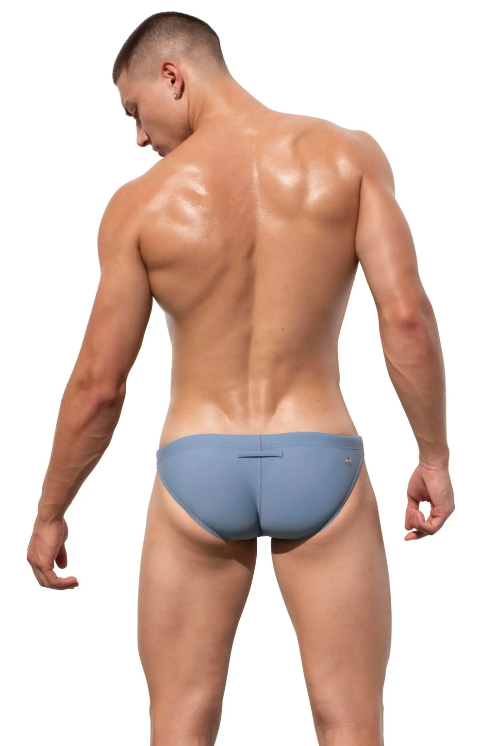 Back view of blue Marcuse Natura bikini swimwear briefs with subtle seam detail designed for athletic use