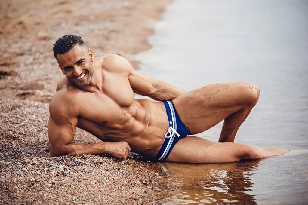 Blue swim trunks with white stripes and drawstring waistband from marcuse ocean bikini swimwear collection