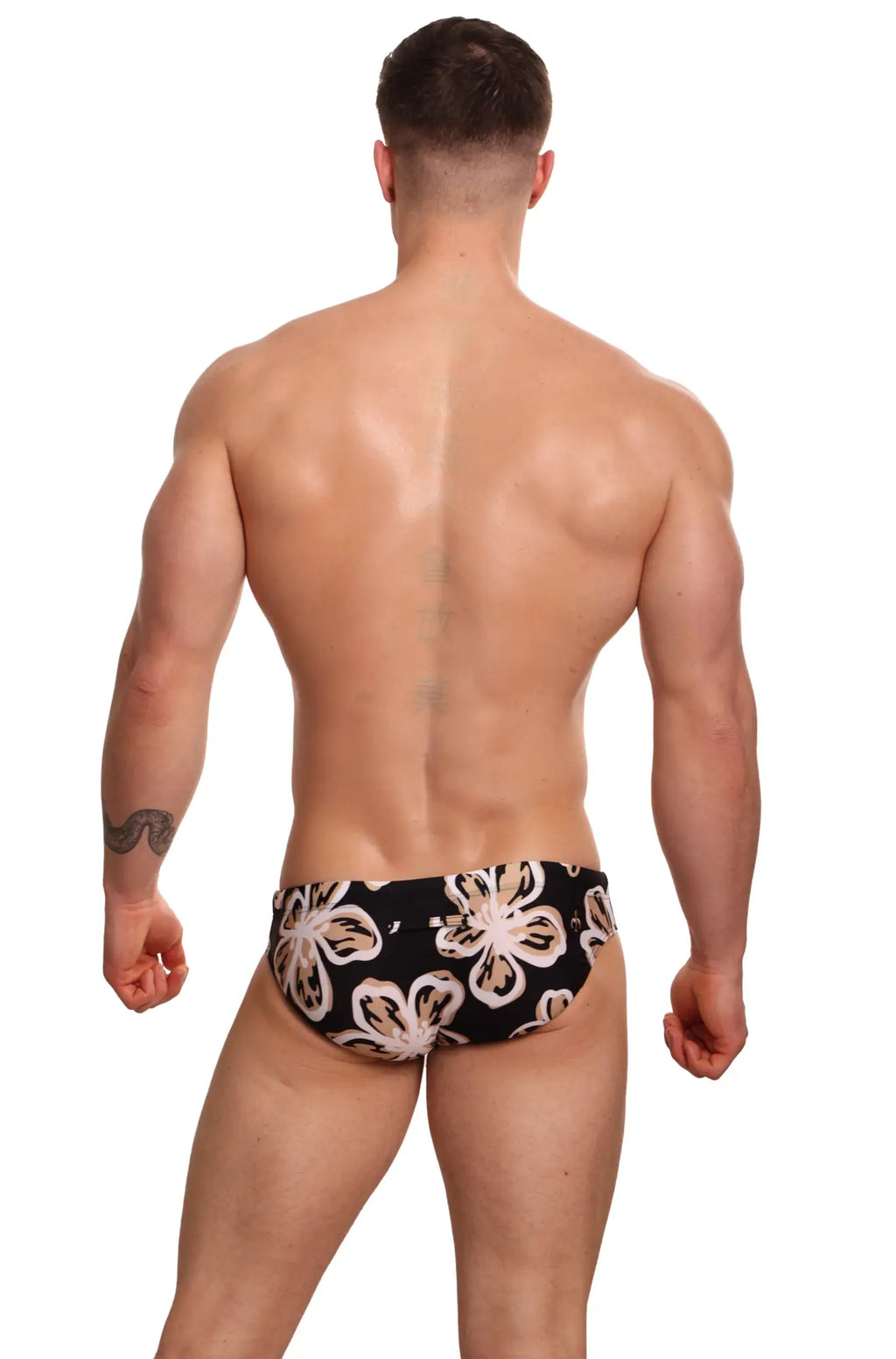 Black swim trunks by Marcuse ornate bikini swimwear with bold cream and beige floral pattern for beachwear