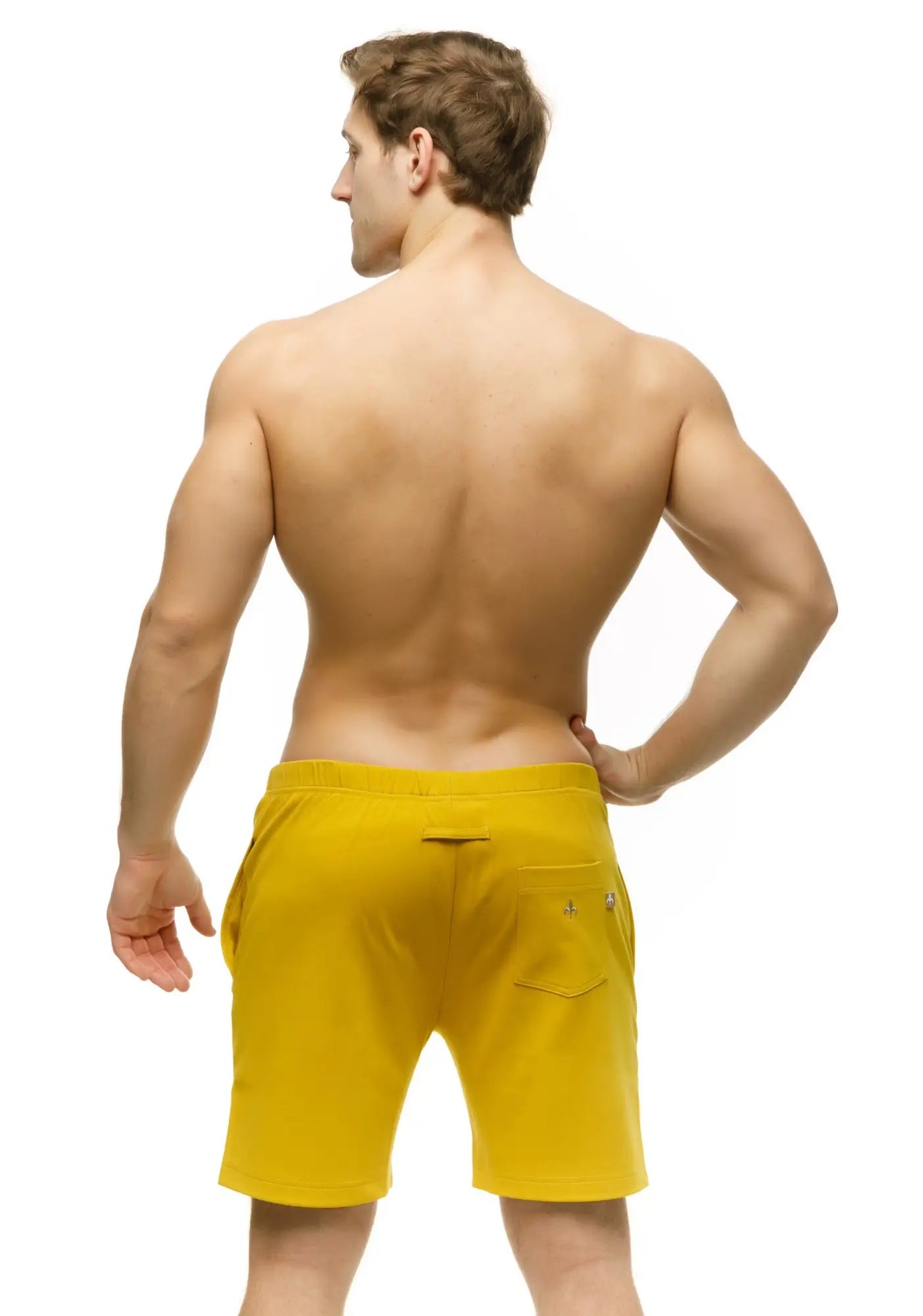 Back side of bright yellow marcuse oxford shorts with subtle logo on the back pocket made from lightweight fabric