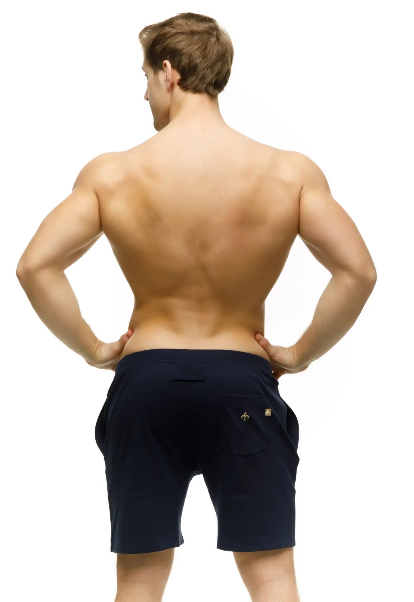 Back side of navy blue Marcuse Oxford athletic shorts with a small gold logo on the back pocket