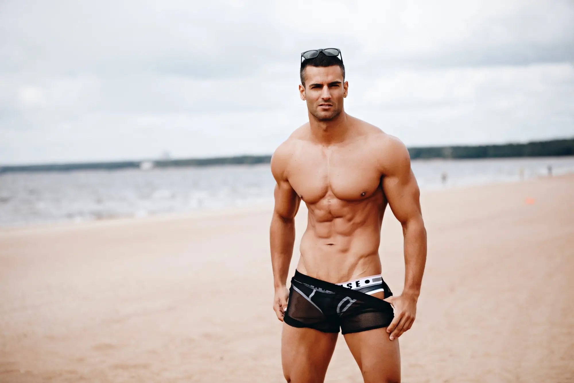 Black mesh marcuse panorama swim trunks with white and gray branding details front view