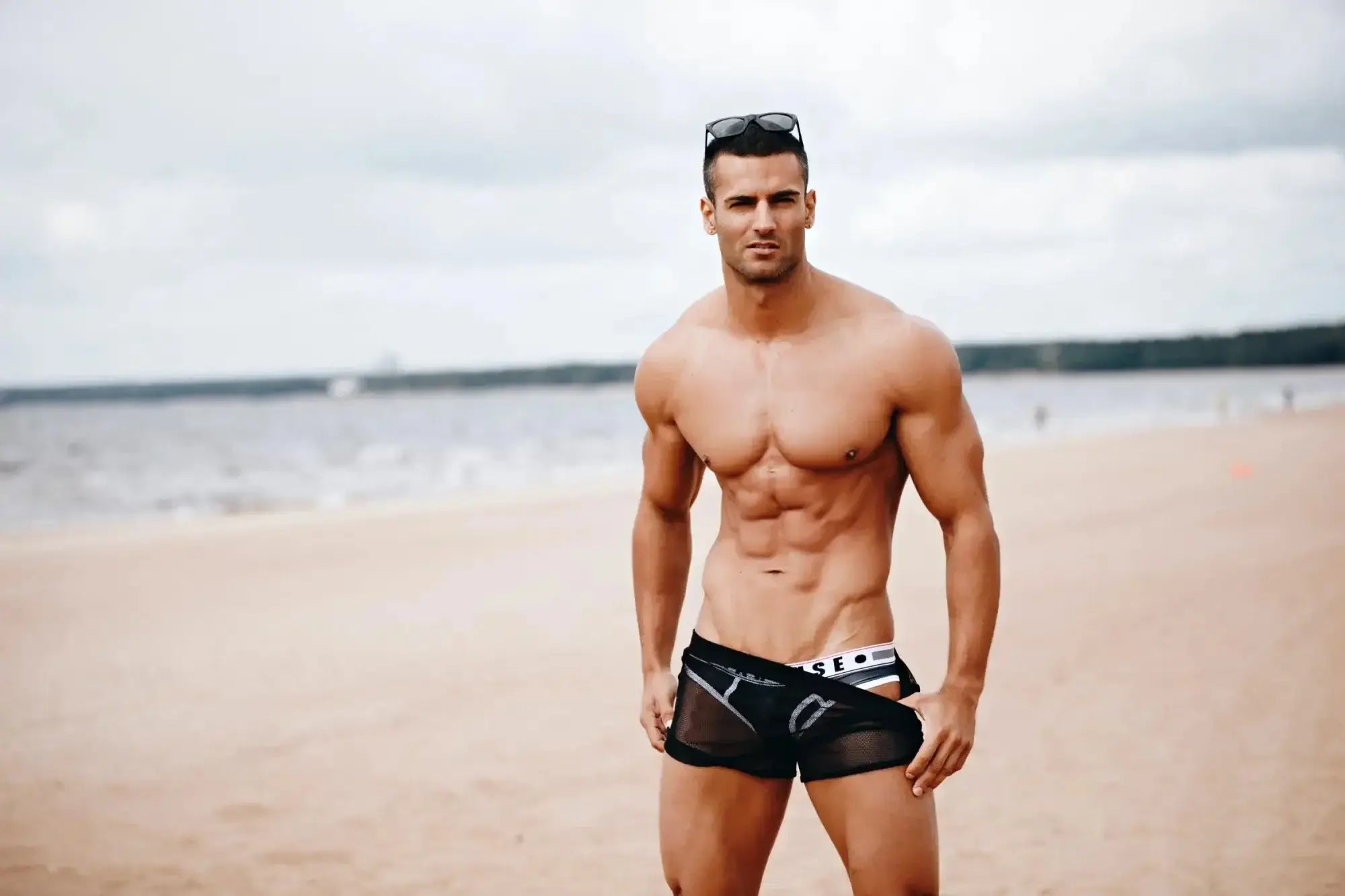 Black mesh marcuse panorama swim trunks with white and gray branding details front view