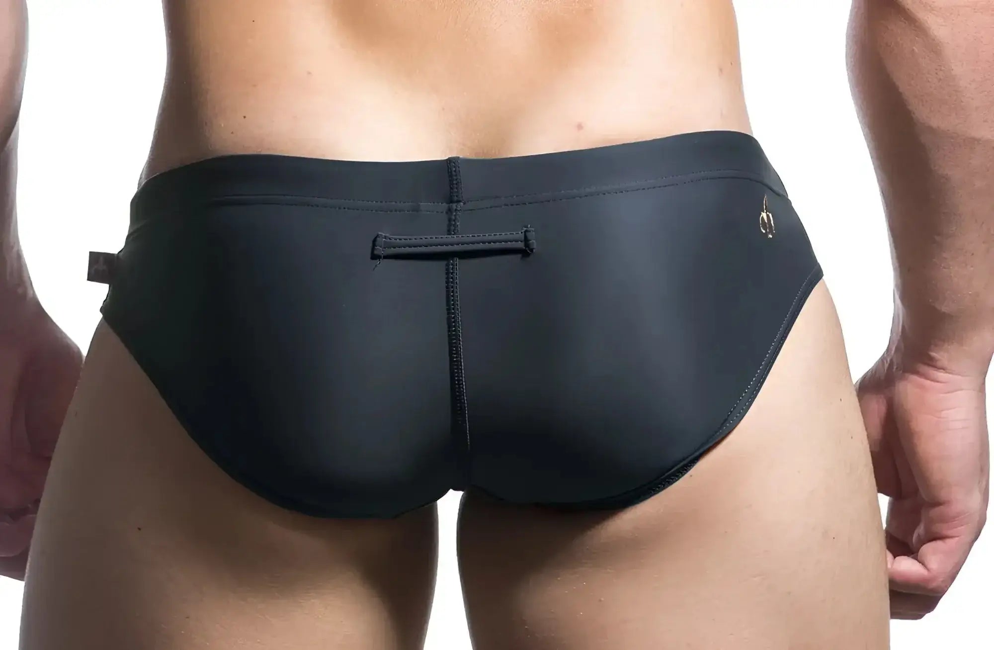 Black Marcuse Patrol bikini swimwear swim trunks with subtle gold logo and central seam detail for swimming