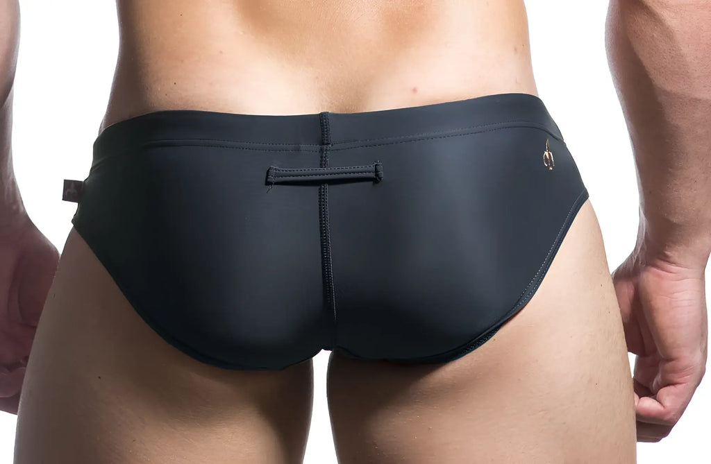 Black Marcuse Patrol bikini swimwear swim trunks with subtle gold logo and central seam detail for swimming